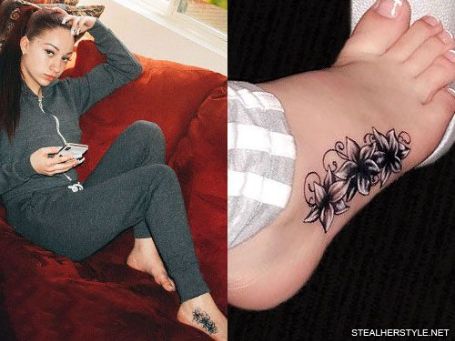 danielle on the couch showing her lilly tattoo on her feet 